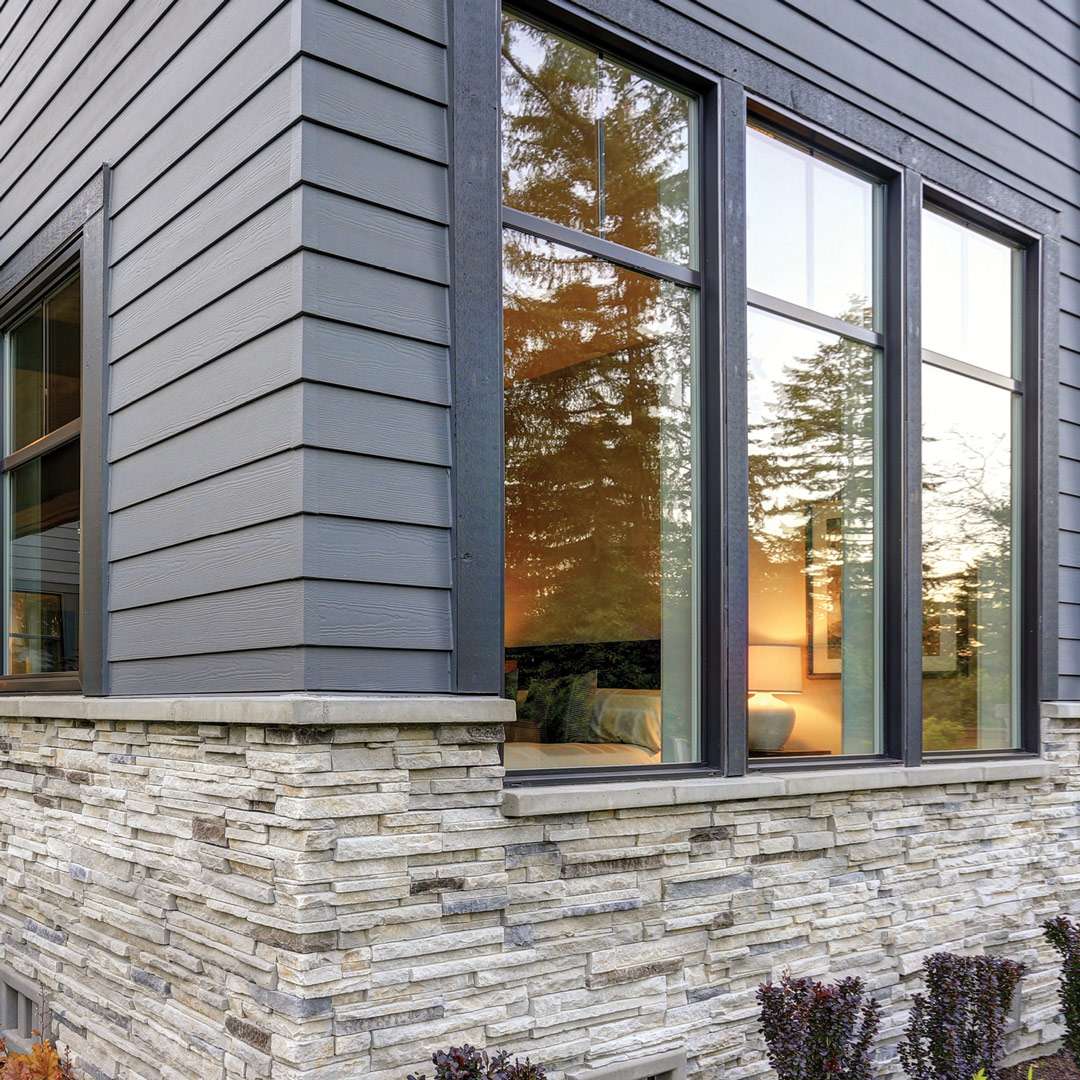 Modern window installation with energy-efficient design and stone exterior, enhancing home aesthetics and comfort.