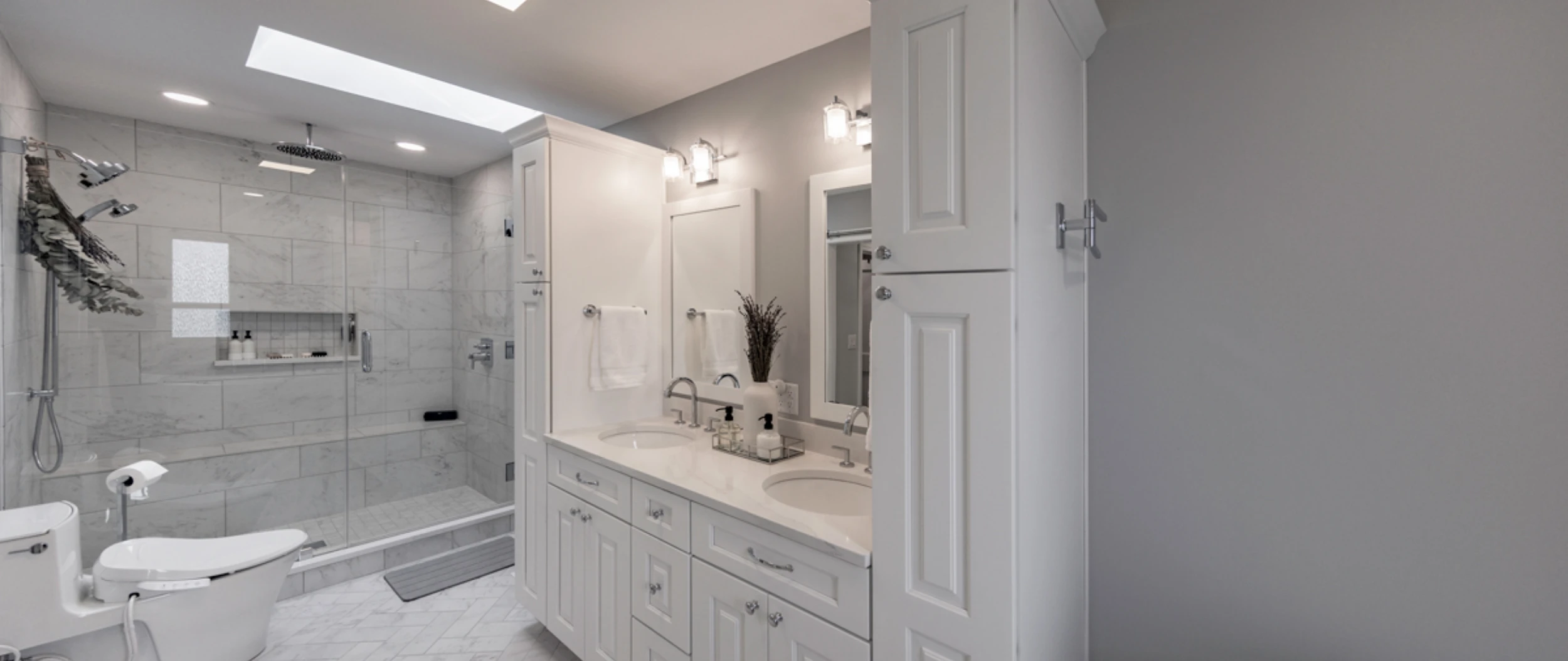 Primary bathroom with double vanity and frameless shower in Clarks Summit, PA