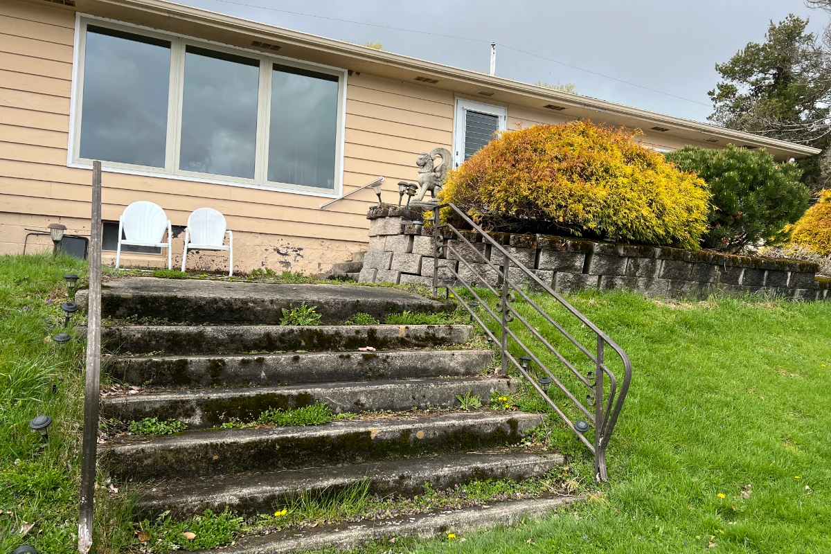 Lake house exterior before deck replacement in Poyntelle, PA