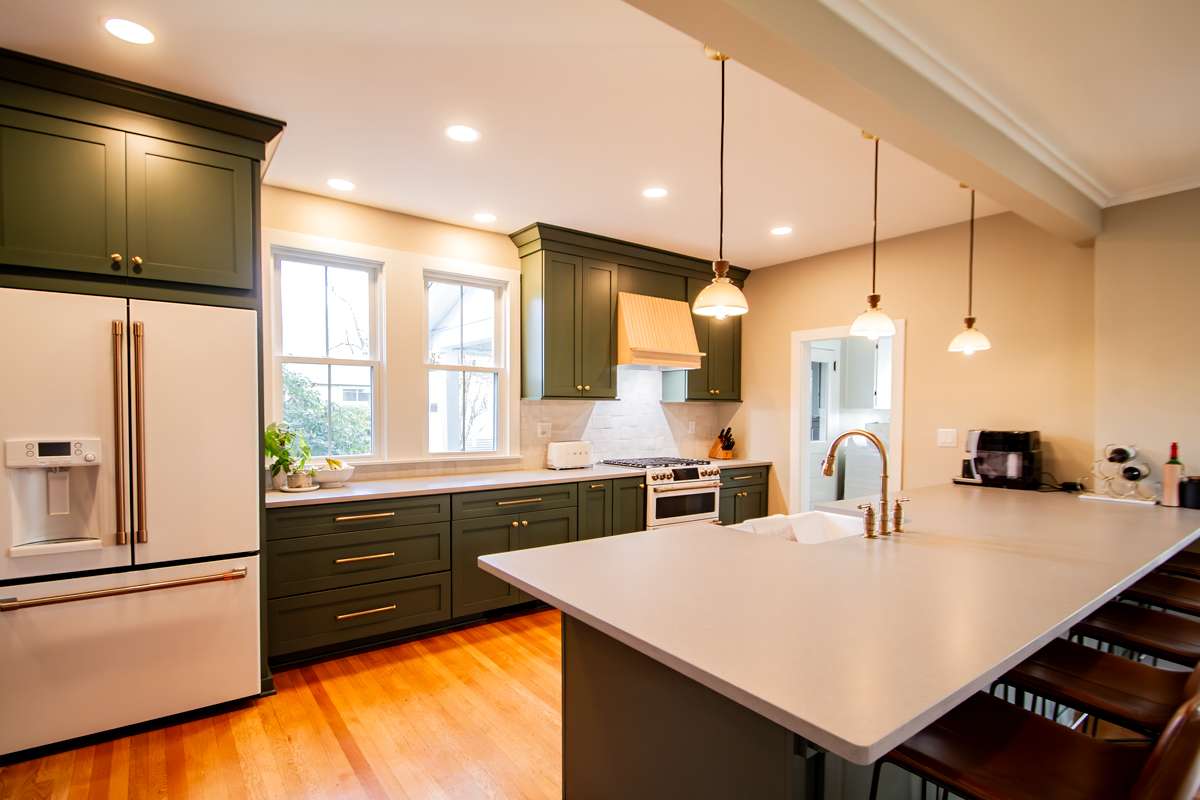 Remodeled kitchen in Clarks Green, PA with Cambria Britannia Gold quartz countertops and full-height backsplash